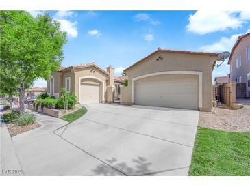 Charming single-story home featuring a three-car garage and meticulously landscaped front yard at 9375 Gold Lake Ave, Las Vegas, NV 89149