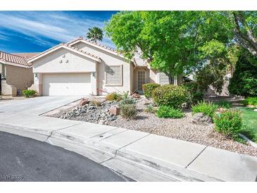 Charming single-story home featuring stucco exterior, tile roof, and well-manicured desert landscaping at 1978 Kachina Mountain Dr, Henderson, NV 89012