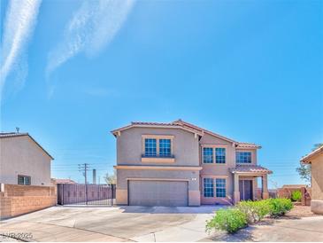 Two-story home featuring a neutral color scheme, a two-car garage, and a well-manicured front yard at 201 Palmarosa St, Henderson, NV 89015
