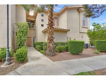 Inviting two-story townhouse showcasing manicured landscaping and a welcoming entrance at 2050 W Warm Springs Rd # 823, Henderson, NV 89014