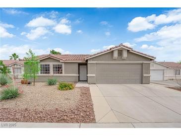 Charming single-story home featuring a low-maintenance desert landscape and a two-car garage at 3102 Honeysuckle Ave, North Las Vegas, NV 89031