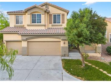Inviting home featuring a three-car garage and well-maintained lawn, creating great curb appeal at 3273 Alcudia Bay Ave, Las Vegas, NV 89141