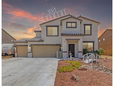 Charming two-story home featuring a three-car garage and desert-style landscaping with rock features at 3821 E Summit Ave, Pahrump, NV 89061
