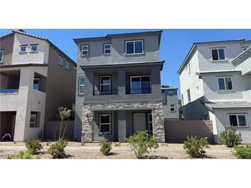 Charming two-story home with stone accents and manicured landscaping in a modern community at 4705 Parkarbor Ave, Las Vegas, NV 89141
