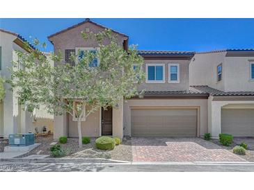Charming two-story home featuring a well-maintained yard, a two-car garage and a classic stucco exterior at 5244 Fiery Sky Ridge St, Las Vegas, NV 89148