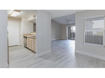 Open-concept living space featuring modern gray flooring and abundant natural light at 555 E Silverado Ranch Blvd # 2164, Las Vegas, NV 89183