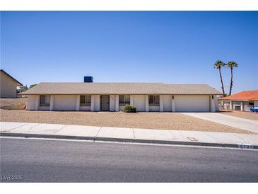 Charming single-story home with desert landscaping and attached two-car garage at 6727 E Washington Ave, Las Vegas, NV 89110