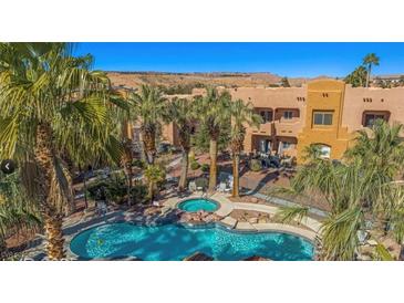 Beautiful community pool with palm trees and a hot tub, perfect for relaxing and enjoying the desert scenery at 728 Hardy Way # E, Mesquite, NV 89027