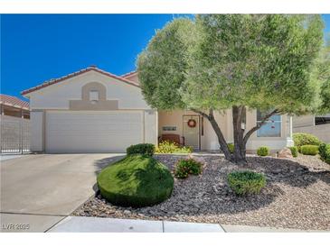Charming single-story home with a well-maintained front yard and mature landscaping at 805 Palmero Way, Boulder City, NV 89005