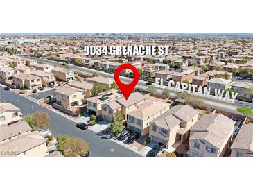 A beautiful aerial view of a suburban house with solar panels on the roof at 9034 Grenache St at 9034 Grenache St, Las Vegas, NV 89148