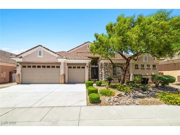 Charming single-story home featuring a three-car garage and stone accents at 2164 Noonday Ct, Henderson, NV 89052