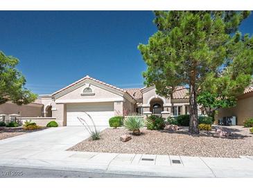 Charming single-story home with a well-manicured front yard and a two-car garage at 2315 Sun Cliffs St, Las Vegas, NV 89134