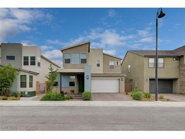 Charming two-story home with a modern design, complemented by blue accents and a well-maintained front yard at 2651 Deep Canyon St, Henderson, NV 89044