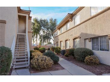 A well-maintained condo building with lush landscaping and pedestrian-friendly sidewalks at 3400 Cabana Dr # 2010, Las Vegas, NV 89122