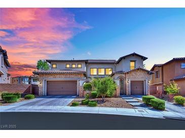 Elegant two-story home showcasing a well-maintained front yard, two-car garage, and stone accents at 362 Port Reggio St, Las Vegas, NV 89138