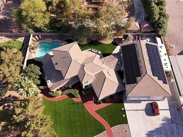 Expansive property featuring a uniquely designed home, pool, well manicured yard and solar panels at 4075 E Oquendo Rd, Las Vegas, NV 89120