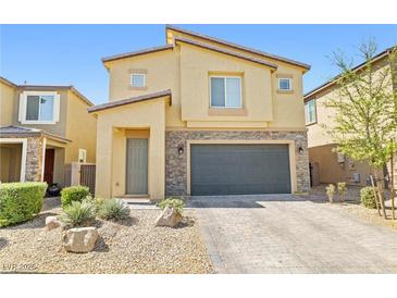 Attractive two-story home with stone accents, a two-car garage, and low-maintenance landscaping at 4519 Stardusk Falls Ave, North Las Vegas, NV 89084