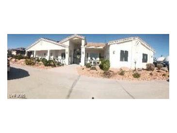 Inviting single story home featuring a desert landscape, covered porch, and long driveway at 60 N Fogg St, Las Vegas, NV 89110