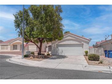 Charming single-story home featuring a two-car garage, desert landscaping, and a mature shade tree at 6624 Old Oxford Ave, Las Vegas, NV 89108