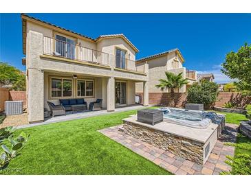 Inviting backyard featuring a spa, patio, well-manicured landscaping, and outdoor seating at 7424 Rainford St, Las Vegas, NV 89148