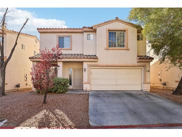 Charming two-story home with a well-manicured lawn and a two-car garage at 7925 Limbwood Ct, Las Vegas, NV 89131