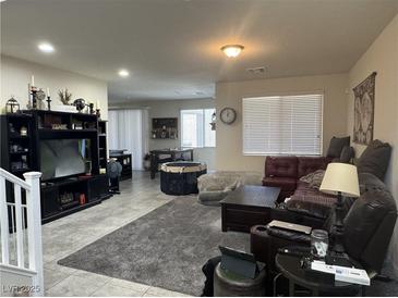Cozy living room featuring plush gray carpet and ample seating at 933 Kimbark Ave, Las Vegas, NV 89148
