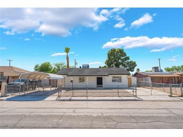 Charming single-story home featuring a fenced yard, car port, and mature trees at 2481 San Marcos St, Las Vegas, NV 89115