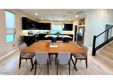 Bright, open-concept dining area featuring modern furnishings and seamlessly connected to the kitchen and living spaces at 8042 Misty Canyon Ave, Las Vegas, NV 89113