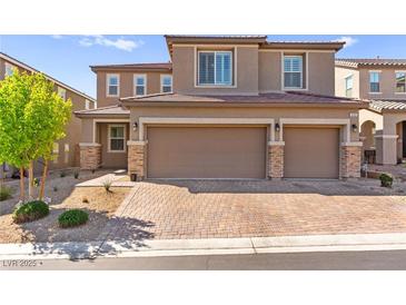 Charming two-story home features a two-car garage and well-manicured front yard at 10101 Heron Lake Ave, Las Vegas, NV 89178