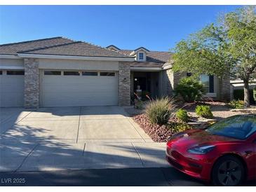 Charming single story home featuring a stone accented facade, manicured landscaping and a spacious driveway at 10816 Elm Ridge Ave, Las Vegas, NV 89144