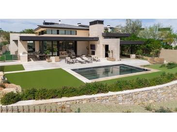 Modern home featuring a rectangular pool, outdoor seating, and an outdoor kitchen perfect for entertaining at 11707 Discovery Canyon Dr, Las Vegas, NV 89135