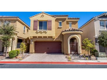 Charming two-story home featuring a red tiled roof, two-car garage, and an arched gated entrance at 1794 Morro Vista Dr, Las Vegas, NV 89135