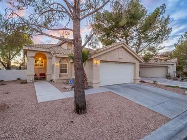 Charming single-story home with a well-manicured front yard, tile roof and a two-car garage at 2521 Seascape Dr, Las Vegas, NV 89128
