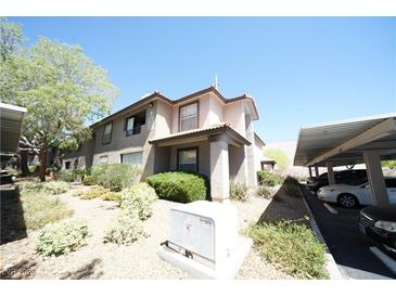 Inviting two-story home with neutral stucco, terracotta roof and carport parking at 2606 S Durango Dr # 165, Las Vegas, NV 89117