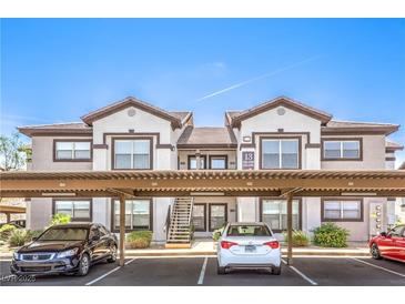 A well-maintained two-story apartment building with carports and landscaped surroundings, perfect for comfortable living at 45 Maleena Mesa St # 1321, Henderson, NV 89074