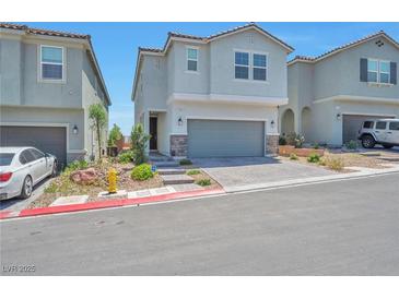 Charming two-story home featuring an attached garage and nicely paved driveway at 5398 Robinera Ct, Las Vegas, NV 89166