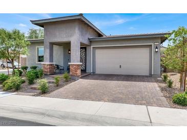 Charming single-story home featuring a welcoming entrance and a two-car garage at 676 Otter Brook St, Henderson, NV 89011