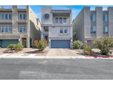 Modern three-story townhome with unique round window and well maintained landscaping at 8060 Haywood Estate Ave, Las Vegas, NV 89113