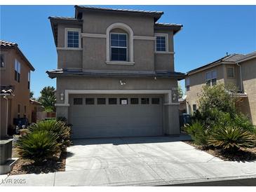 Two story home featuring desert landscaping and a two car garage at 8745 Dodds Canyon St, Las Vegas, NV 89131