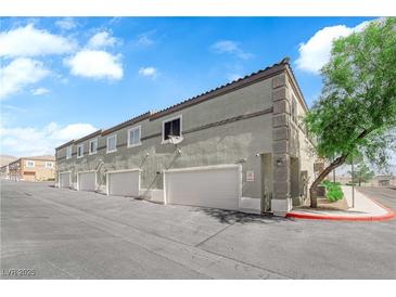 Attractive townhome featuring private garage and well-maintained landscaping at 10450 Gold Shadow Ave, Las Vegas, NV 89129