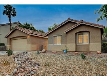 Charming single-story home with desert landscaping, a detached garage, and a welcoming exterior at 10712 Aire Dr, Las Vegas, NV 89144
