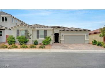 Charming single-story home featuring a two-car garage, desert landscaping, and a welcoming front porch at 2433 Amatrice St, Henderson, NV 89044