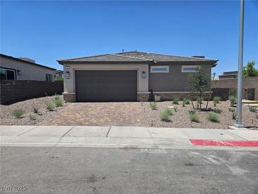 Charming single-story home featuring a two-car garage, tidy landscaping, and a well-maintained exterior at 289 Aravalli Crest St, Henderson, NV 89015
