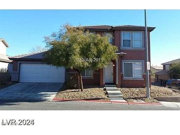 Two-story home with a two car garage, small tree and neutral colored exterior in a residential neighborhood at 5308 La Quinta Hills St, North Las Vegas, NV 89081