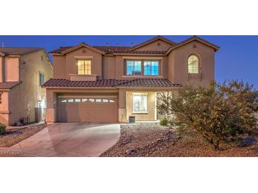 Charming two-story home boasts a well-manicured lawn, covered entry, and attached two-car garage at 5480 Oatfield St, North Las Vegas, NV 89081