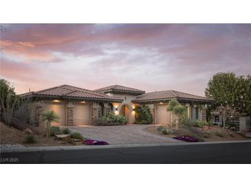 Stunning home showcasing a three-car garage, desert landscaping, and inviting curb appeal at dusk at 64 Tapadero Ln, Las Vegas, NV 89135