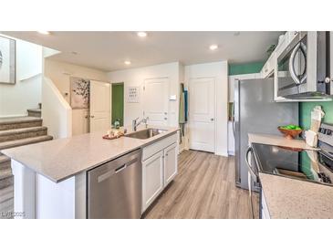 Modern kitchen boasts stainless steel appliances, gray countertops, and white cabinets at 6922 Wrightshire St # 22, Las Vegas, NV 89166