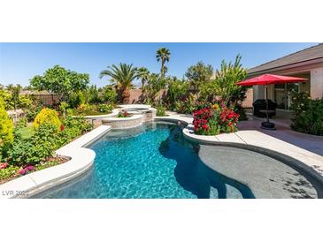 Inviting pool and spa with lush landscaping create a private backyard oasis at 8221 Bay Dunes St, Las Vegas, NV 89131