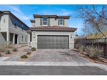 Two-story home featuring a tile roof, paired garage, and neat landscaping, presenting a well-kept exterior at 9330 Brookmont Ave, Las Vegas, NV 89149
