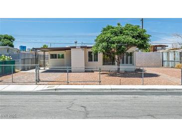 Charming single-story home with desert landscaping and chain-link fence at 1720 Eastwood Dr, Las Vegas, NV 89104